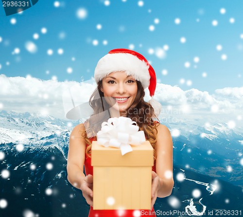 Image of smiling woman in red dress with gift box