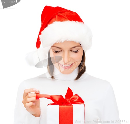 Image of smiling woman in santa helper hat with gift box