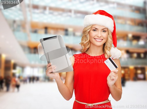 Image of woman in santa hat with tablet pc and credit card