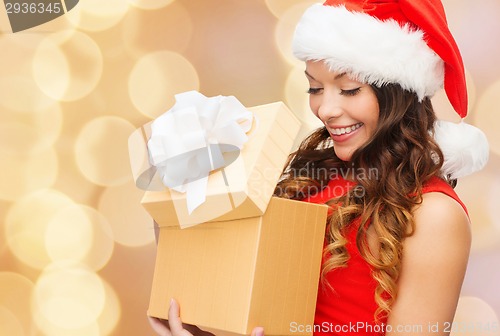 Image of smiling woman in red dress with gift box
