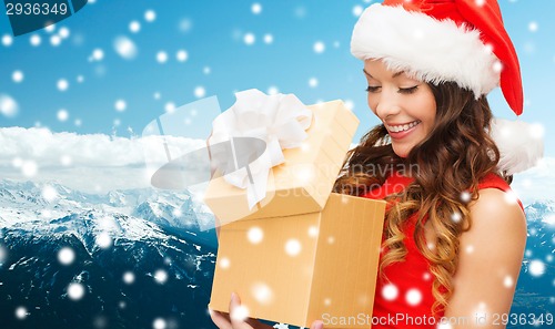 Image of smiling woman in red dress with gift box