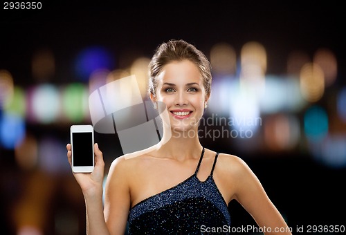 Image of smiling woman in evening dress with smartphone