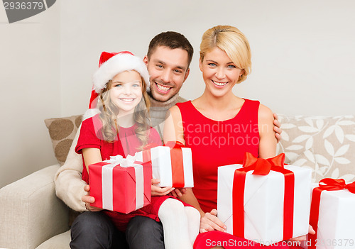 Image of smiling family holding many gift boxes