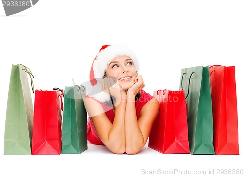 Image of woman in red shirt with shopping bags