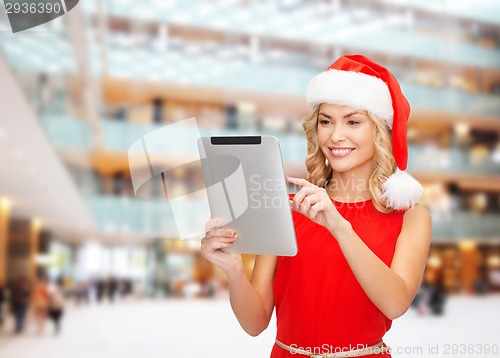 Image of woman in santa helper hat with tablet pc