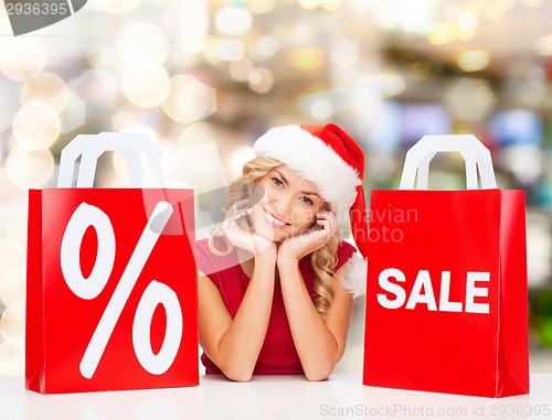 Image of woman in red dress with shopping bags