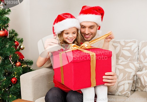 Image of smiling father and daughter opening gift box