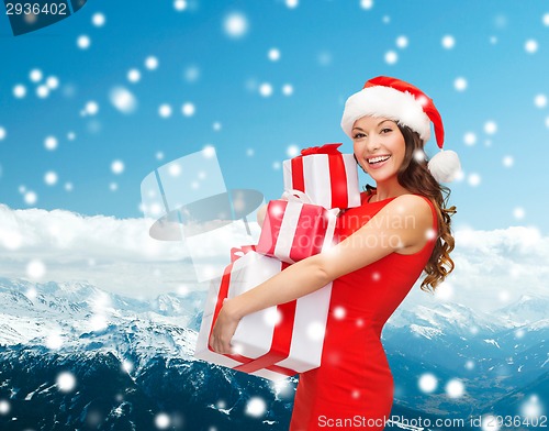 Image of smiling woman in red dress with gift box