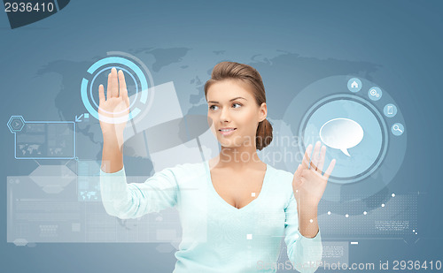 Image of smiling businesswoman working with virtual screen