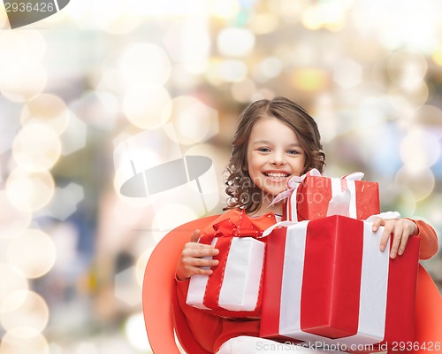 Image of smiling little girl with gift boxes