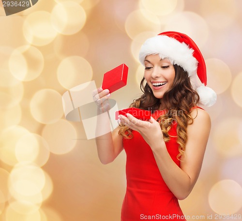 Image of smiling woman in red dress with gift box
