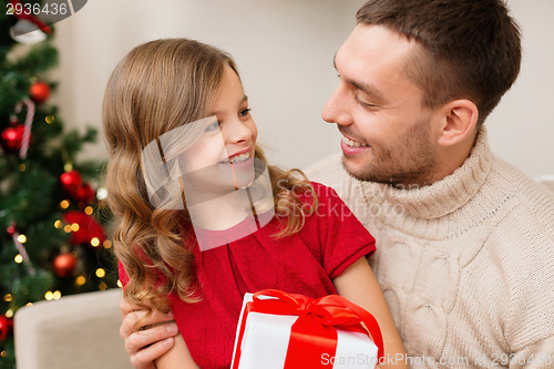 Image of smiling father and daughter looking at each other