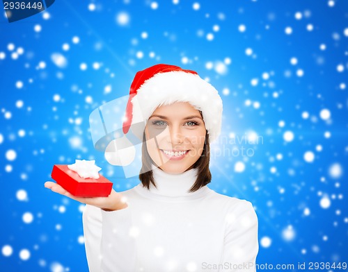 Image of smiling woman in santa helper hat with gift box
