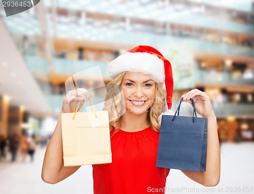 Image of woman in santa helper hat with shopping bags