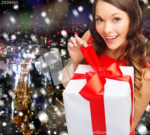 Image of smiling woman in red dress with gift boxes