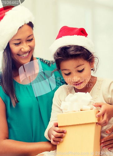Image of happy mother and child girl with gift box