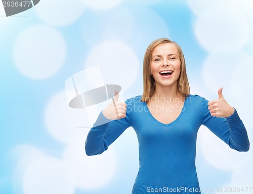 Image of smiling girl in casual clothes showing thumbs up