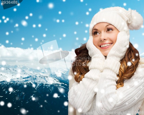 Image of smiling young woman in white winter clothes