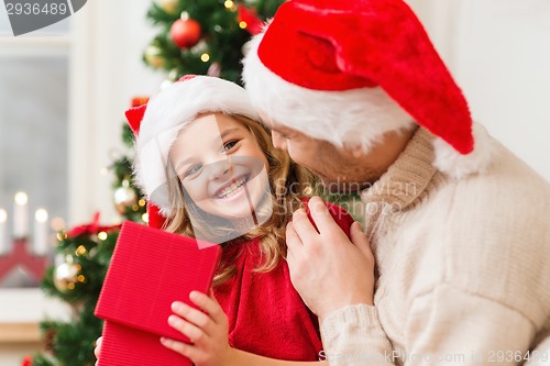 Image of smiling father and daughter opening gift box