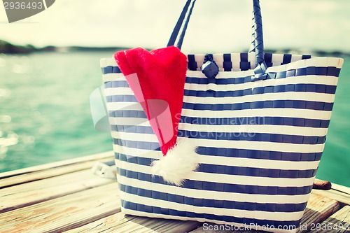 Image of close up of beach bag and santa helper hat