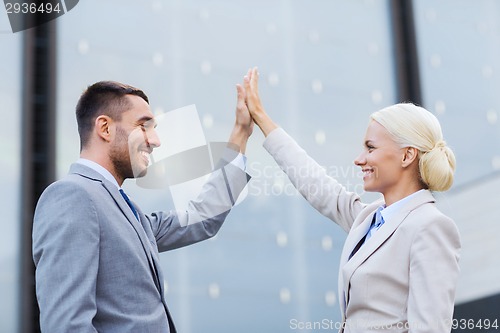 Image of smiling businessmen outdoors