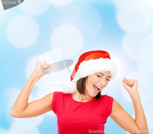 Image of smiling woman in santa helper hat