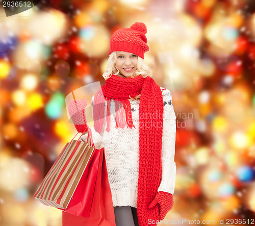 Image of teenage girl in winter clothes with shopping bags