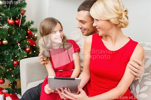 Image of smiling family with tablet pc