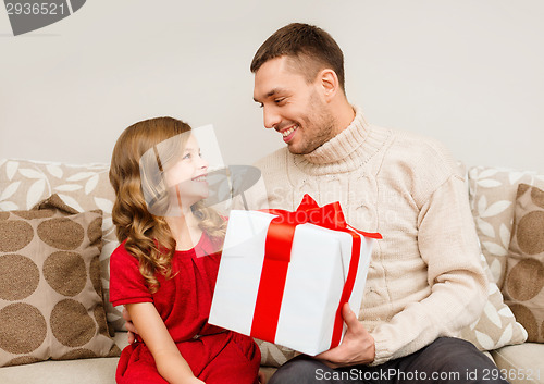 Image of smiling father and daughter looking at each other