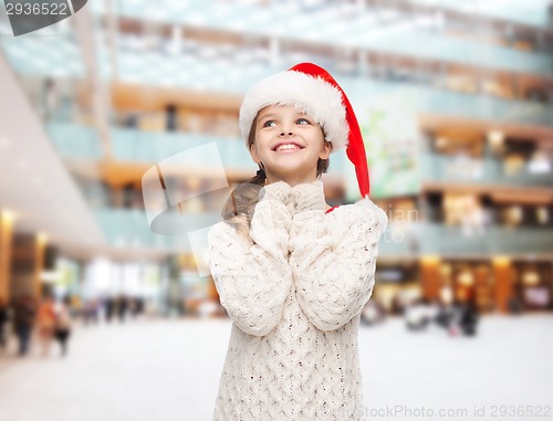 Image of dreaming girl in santa helper hat
