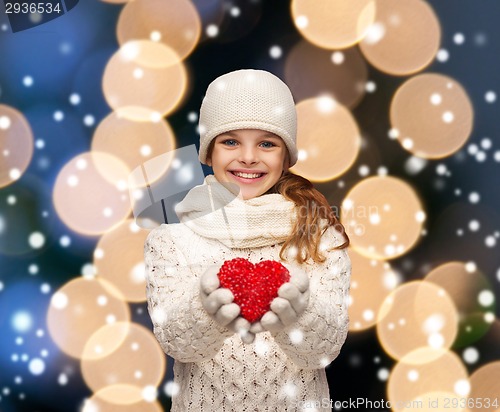 Image of girl in winter clothes with small red heart