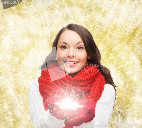 Image of smiling woman in winter clothes with snowflake