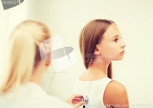 Image of doctor with stethoscope listening to the patient