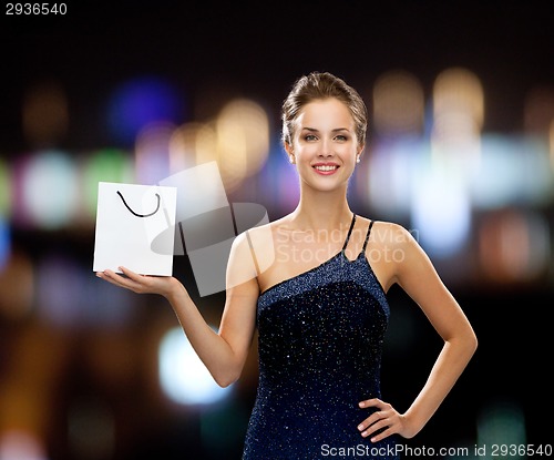 Image of smiling woman with white blank shopping bag