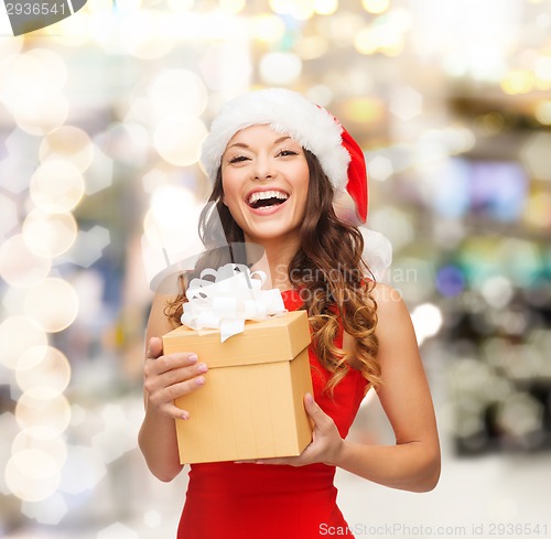 Image of smiling woman in santa helper hat with gift box