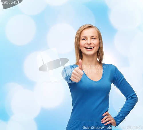 Image of smiling girl in casual clothes showing thumbs up