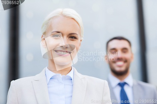 Image of smiling businessmen outdoors