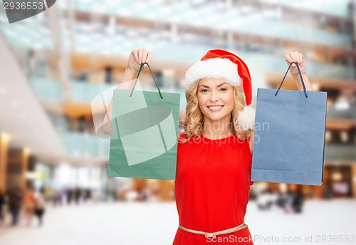 Image of woman in santa helper hat with shopping bags