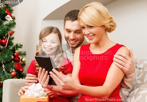 Image of smiling family with tablet pc