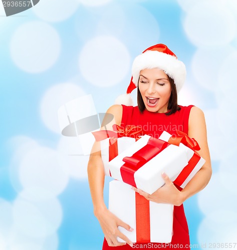 Image of smiling woman in red dress with gift box
