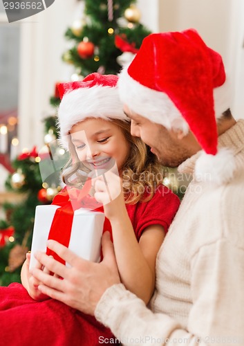 Image of smiling father and daughter opening gift box