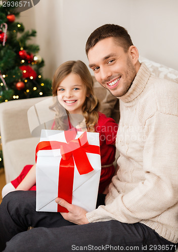 Image of smiling father and daughter holding gift box