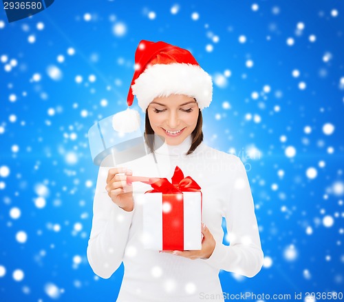 Image of smiling woman in santa helper hat with gift box