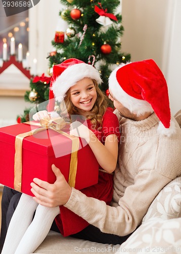 Image of smiling father and daughter opening gift box