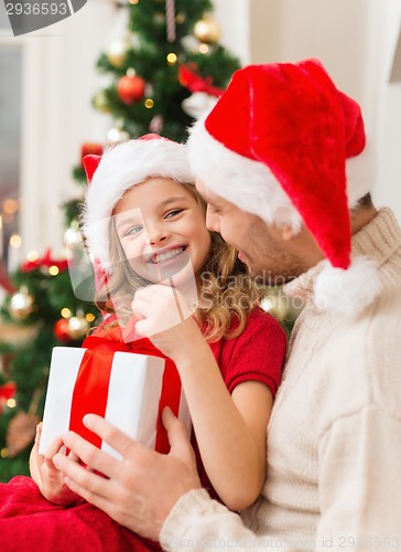 Image of smiling father and daughter opening gift box