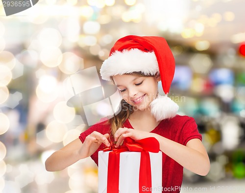 Image of smiling girl in santa helper hat with gift box