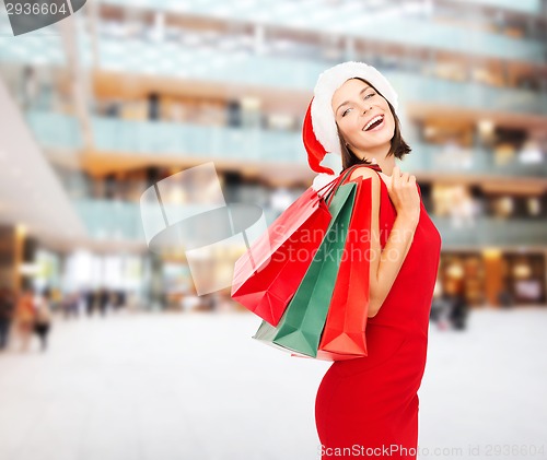 Image of woman in red dress with shopping bags