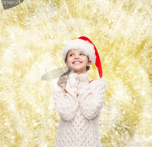 Image of dreaming girl in santa helper hat