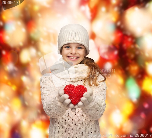 Image of girl in winter clothes with small red heart