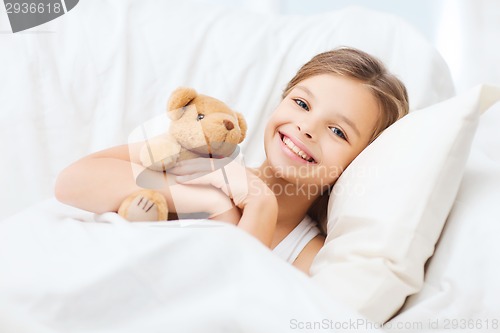 Image of little girl with teddy bear sleeping at home